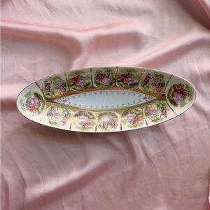 Vintage oblong porcelain dish with images of a courting couple and gold details
